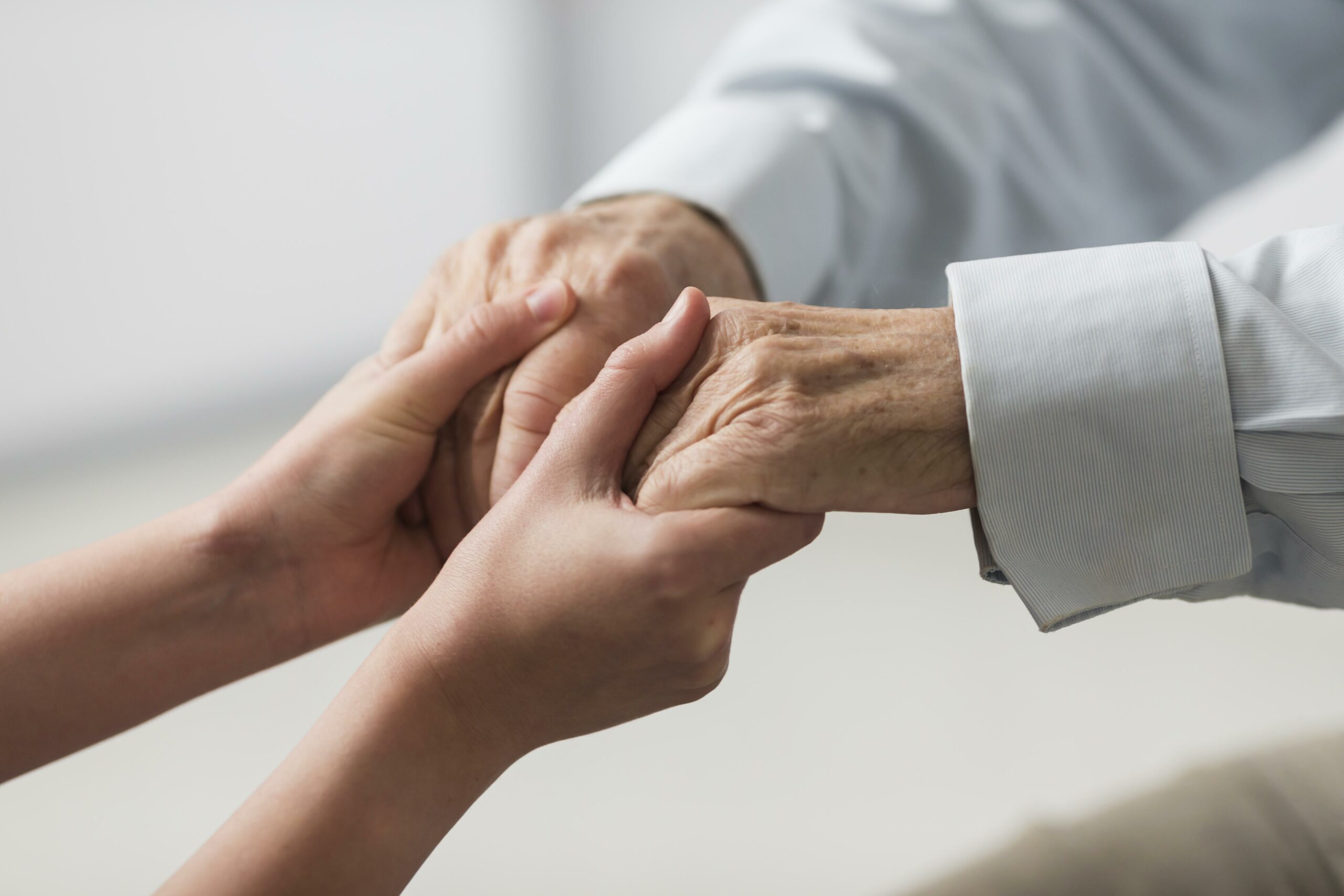 nurse-holding-senior-man-s-hands-sympathy-1